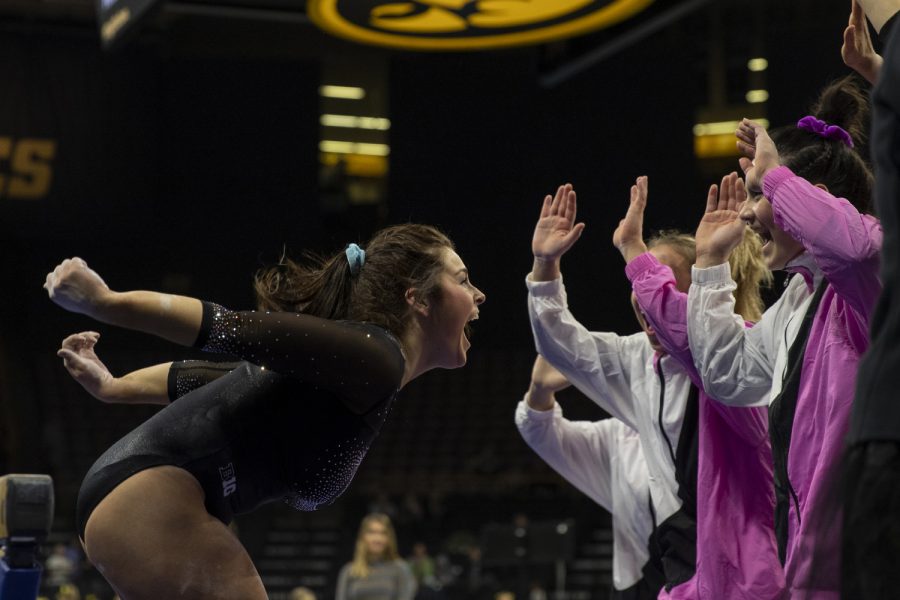 Iowa’s all-around Erin Castle celebrates with her teammates after performing on the beam during a gymnastics meet between Iowa and Michigan at Carver Hawkeye Arena on Friday, Feb. 14, 2020. The GymHawks were defeated by the Wolverines with a score, 195.975-196.800. Castle earned a score of 9.800. 