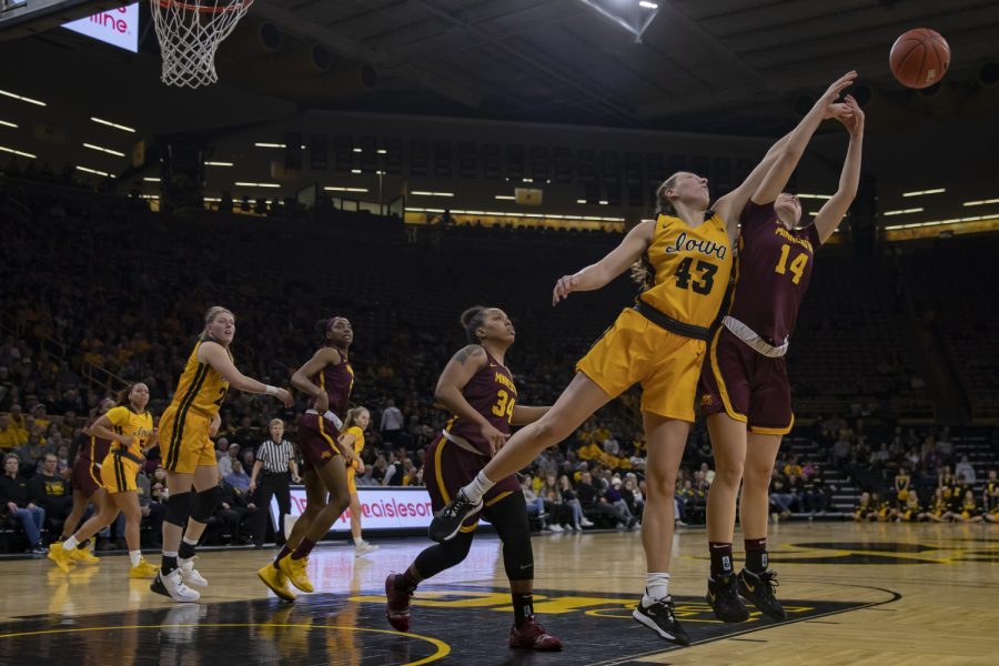 Iowa forward Amanda Ollinger reaches for the ball during a womens basketball game between Iowa and Minnesota at Carver Hawkeye Arena on Thursday, Feb. 27, 2020. The Hawkeyes defeated the Gophers, 90-82. 
