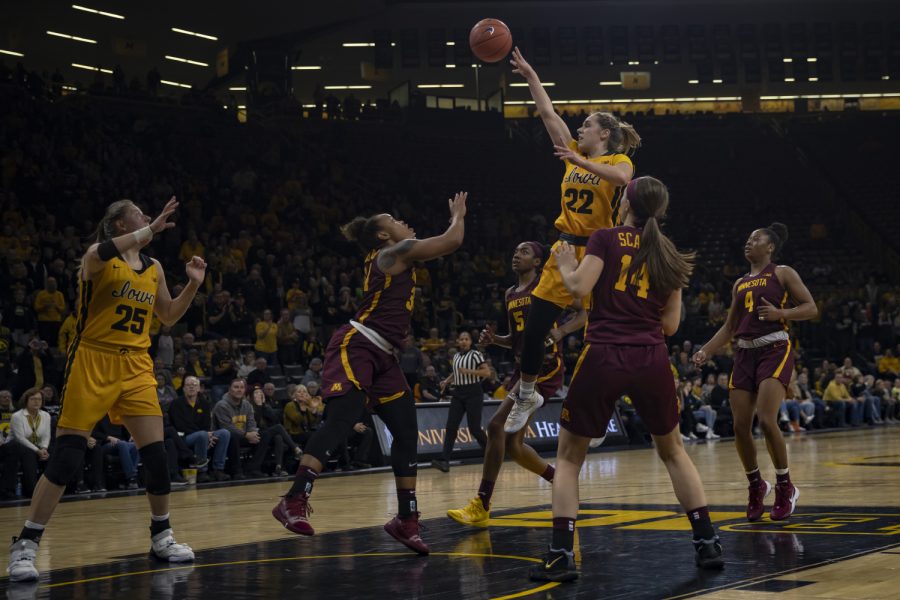 Iowa guard Kathleen Doyle fakes a shot and passes the ball during a women's basketball game between Iowa and Minnesota at Carver Hawkeye Arena on Thursday, Feb. 27, 2020. The Hawkeyes defeated the Gophers, 90-82. 