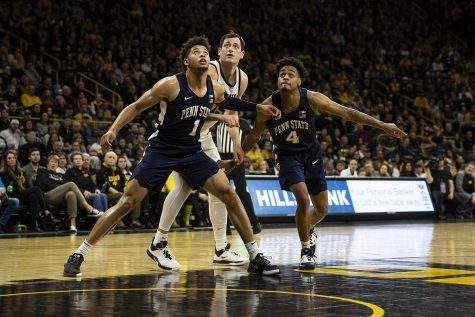Penn State guards Seth Lundy and Curtis Jones Jr. fight Iowa forward Ryan Kriener for a rebound during a men’s basketball game between Iowa and Penn State on Saturday, Feb. 29 at Carver-Hawkeye Arena. The Hawkeyes defeated the Nittany Lions 77-68. 