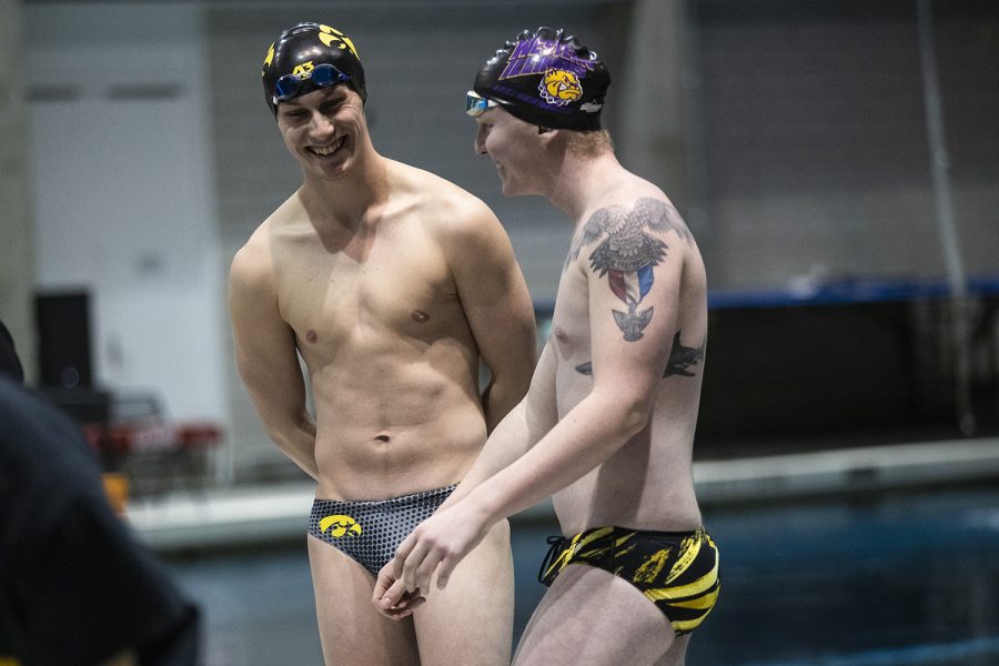 An Iowa swimmer and a Western Illinois swimmer bond during a dual between Iowa and Western Illinois on Friday, February 7, 2020 at the University of Iowa Campus Recreation and Wellness Center. The Iowa women’s team defeated Western Illinois 130 to 67, while the Iowa men’s team defeated Western Illinois 122 to 44. 
