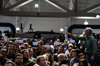 Supporters of Sen. Elizabeth Warren, D-Mass., hold up cards during the caucus at Des Moines Precinct 62 in the Knapp Center on Monday, February 3, 2020. The caucus head count reached 849 people, leaving 127 individuals needed for the candidate to be declared viable. Sen. Warren received 212 1st round total head count votes. 