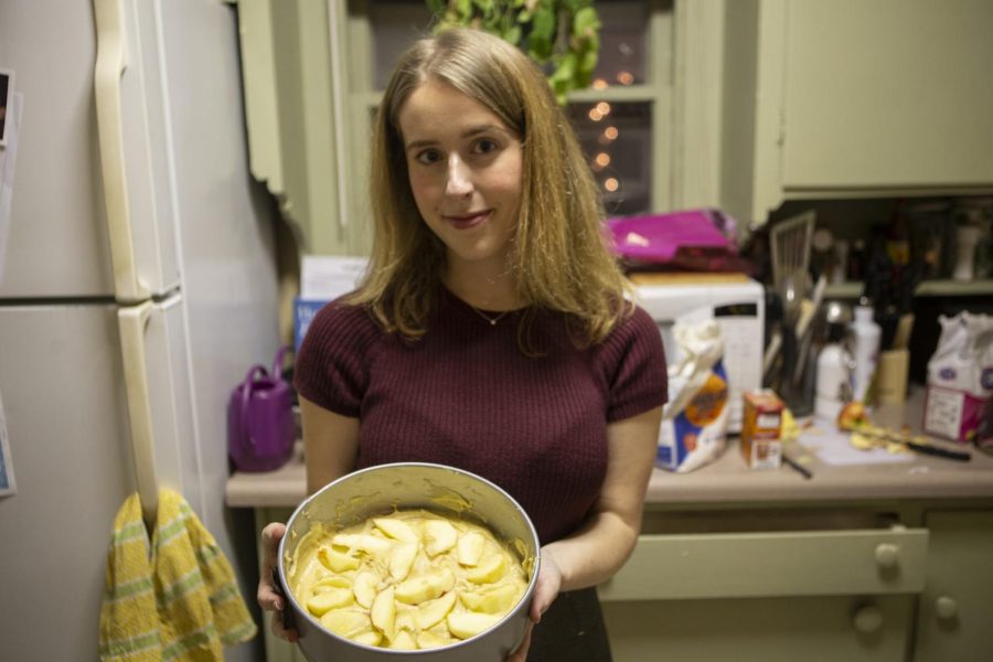 Addie Bushnell prepares an apple torte in her apartment, which is inspired by a recipe from a cookbook called “The Original Recipes from Busnell’s Turtle.” Bushnell’s Turtle was a prominent restaurant in Iowa City in the late 20th century that Addie Bushnell is now bringing to life through her three-part project, “Bushnell Recipe Series.” (Jake Maish/The Daily Iowan)