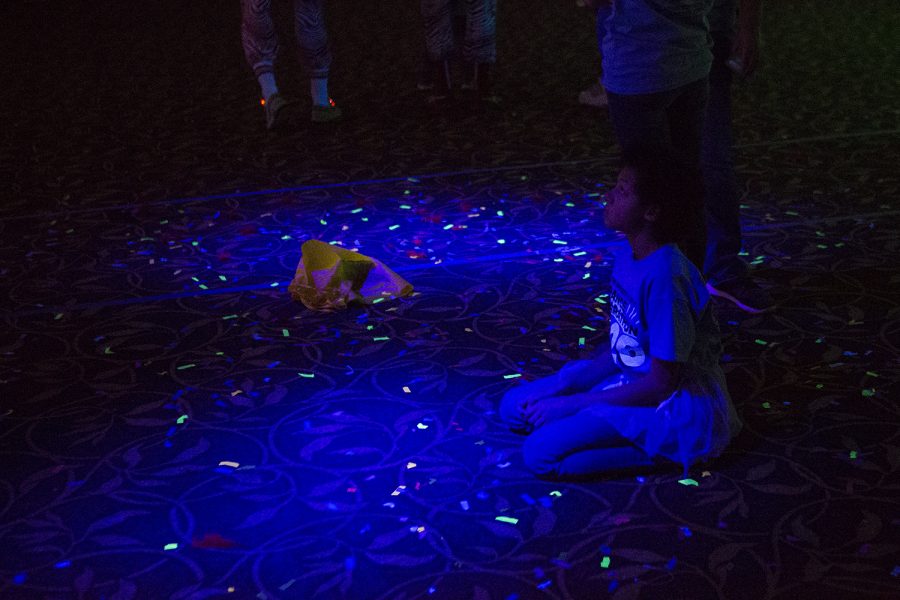 A dancer sits on the ballroom floor at Dance Marathon in the IMU on Saturday, February 8, 2020. 