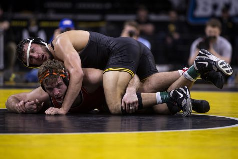 Iowa’s 174-pound Michael Kemerer grapples with Oklahoma State’s Joe Smith during a wrestling dual meet between No 1. Iowa and No. 9 Oklahoma State at Carver-Hawkeye Arena on Sunday, Feb. 23, 2020.  No. 1 Kemerer defeated No. 13 Smith by major decision, 12-2, and the Hawkeyes defeated the Cowboys, 34-6.