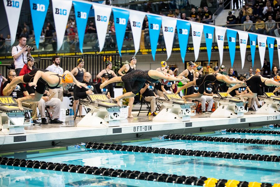 Swimmers dive into the pool during the 100 Breast during the second session of the the 2020 Big Ten Womens Swimming and Diving Championship at the the HTRC on Friday, Feb. 21, 2020. 