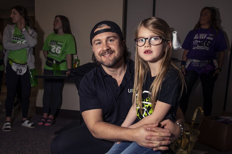 Thompson and Company Owner Bobby Thompson poses for a portrait with his daughter Lola Thompson during the Short Hair Dont Care event at Dance Marathon 26 in the IMU on Feb. 8, 2019. Thompson has been cutting hair for the event for four years. (Ryan Adams/The Daily Iowan)