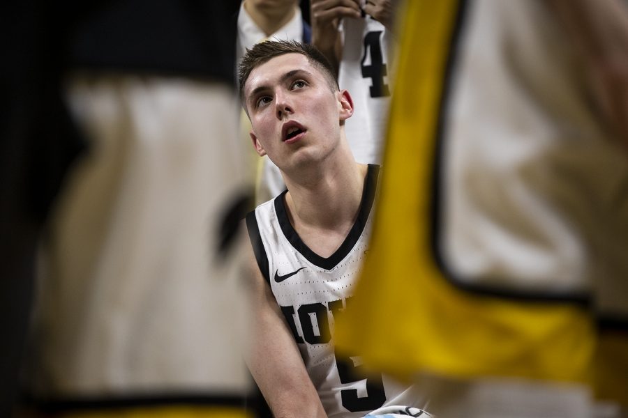 Iowa guard CJ Fredrick listens intently during a timeout during a men’s basketball game between Iowa and Penn State on Saturday, Feb. 29 at Carver-Hawkeye Arena. (Nichole Harris/The Daily Iowan)