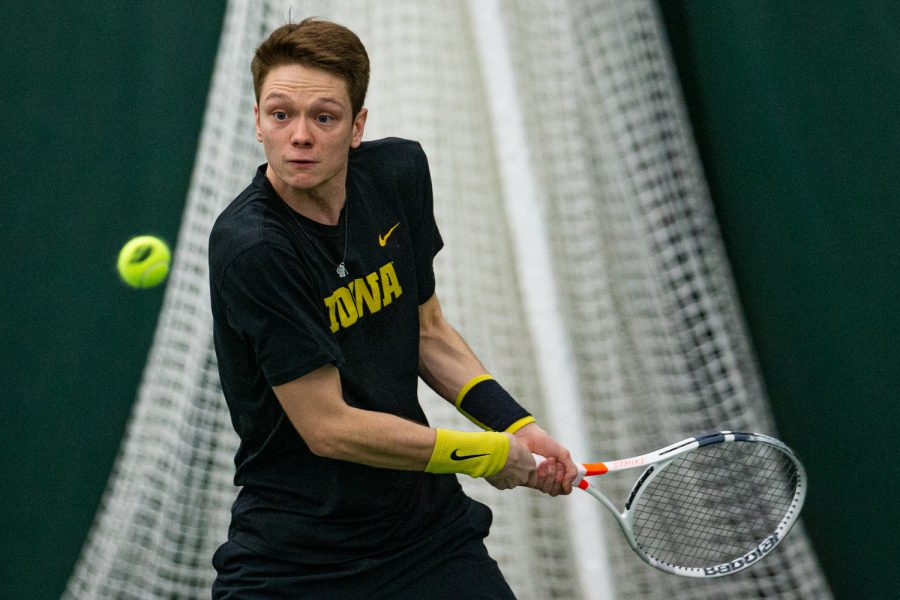 Iowas Jason Kerst hits a backhand during a mens tennis match between Iowa and VCU on Saturday, Feb. 29, 2020. The Hawkeyes defeated the Rams, 4-3.