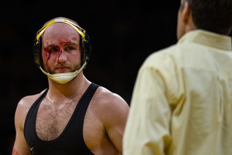 Iowas Alex Marinelli has blood cleaned off his face during a wrestling dual meet between No. 1 Iowa and No. 2 Penn State at Carver-Hawkeye Arena on Friday, Jan. 31, 2020. The Hawkeyes defeated the Nittany Lions, 19-17.