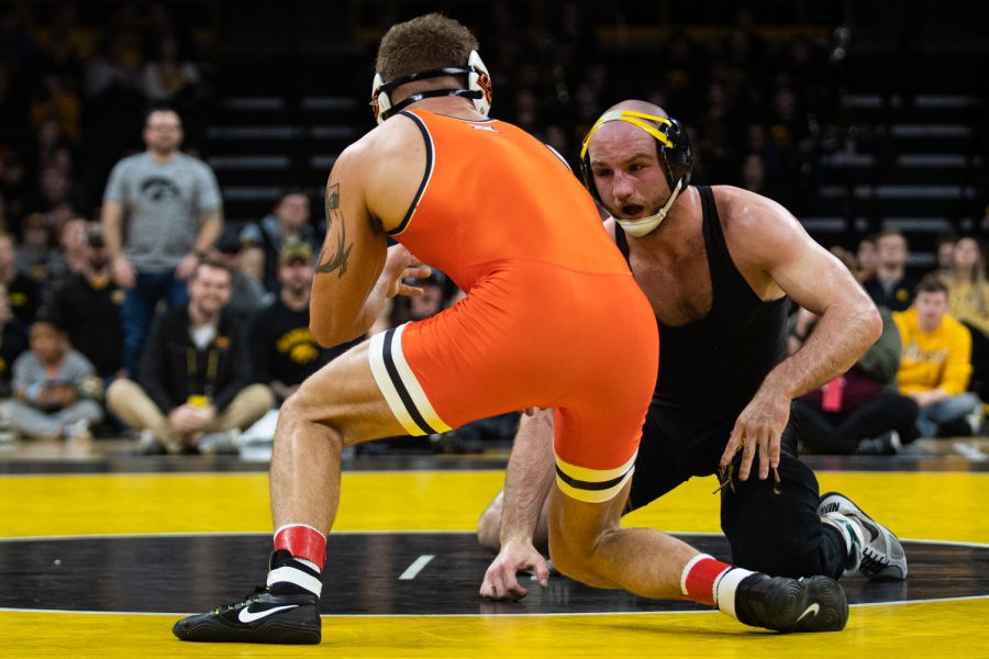 Iowa’s 165-pound Alex Marinelli grapples with Oklahoma State’s Travis Wittlake during a wrestling dual meet between No. 1 Iowa and No. 9 Oklahoma State at Carver-Hawkeye Arena on Sunday, Feb. 23, 2020. No. 2 Marinelli defeated No. 6 Wittlake by decision, 3-2, and the Hawkeyes defeated the Cowboys, 34-6.