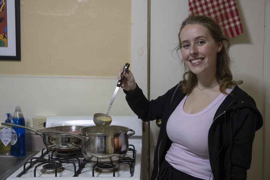 The Daily Iowan Arts reporter Addie Bushnell poses for a portrait after making corn chowder from The Original Recipes of the Bushnell’s Turtle on Tuesday, Feb. 25, 2020.