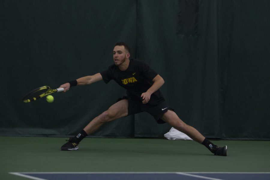 Iowa’s Kareem Allaf reaches for the ball during a men’s tennis match between Iowa and Louisville on Friday, March 6, 2020 at The Hawkeye Tennis & Recreation Complex. The Hawkeyes defeated the Cardinals 4-1. 