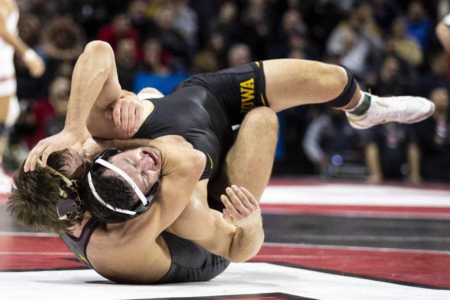 Iowas 174-pound Michael Kemerer grapples with Minnesotas Devin Skatzka during session two of the Big Ten Wrestling Tournament in Piscataway, NJ on Saturday, March 7, 2020. Kemerer won by major decision, 22-9. ]
