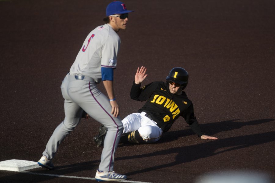 Iowa outfielder Justin Jenkins slides into third during a baseball game between the Iowa Hawkeyes and the Kansas Jayhawks on Tuesday, March 10, at Duane Banks Field. The Hawkeyes defeated the Jayhawks, 8-0. 