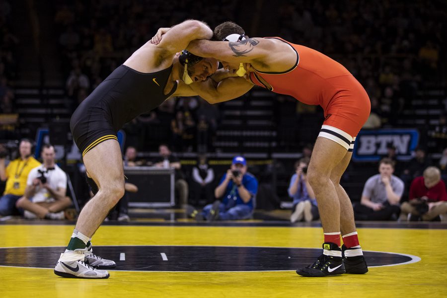 Iowa’s 165-pound Alex Marinelli grapples with Oklahoma State’s Travis Wittlake during a wrestling dual meet between No 1. Iowa and No. 9 Oklahoma State at Carver-Hawkeye Arena on Sunday, Feb. 23, 2020.  No. 2 Marinelli defeated No. 6 Wittlake by decision, 3-2, and the Hawkeyes defeated the Cowboys, 34-6.