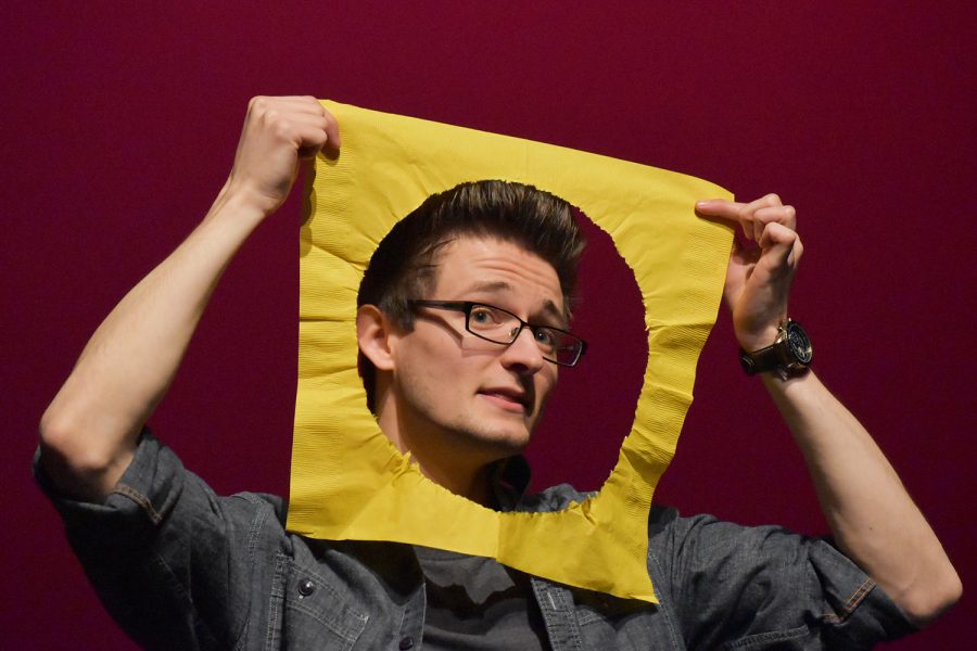 Comedian and magician Grant Freeman makes a man in the moon joke while telling a story at the Coralville Center for Performing Arts on Wednesday March 4, 2020.