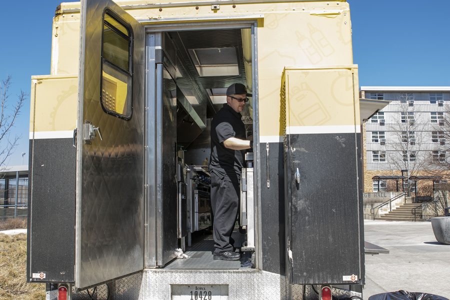 Street Hawk cook Ben Cremer works in the Street Hawk truck on Monday, March 30, 2020. Campus was empty as students began their first day of online classes. Cremer said they served not even 10 people that afternoon, when they'd typically serve between 200 and 300.