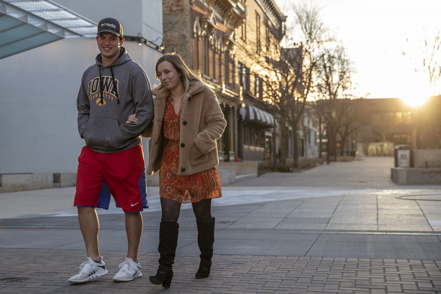 UI senior Matthew Whittle and first-year law student Bryony Whitaker walk downtown on Saturday, April 4, 2020. Downtown was quiet during the first weekend after spring break as classes have been moved online and the bars closed due to the coronavirus. 