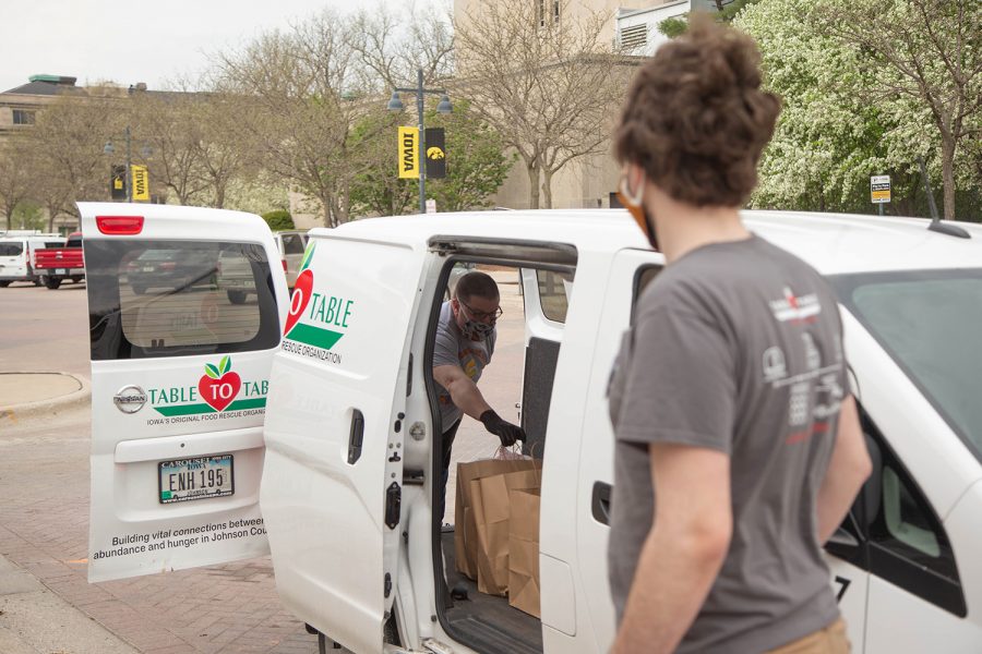 Table to Table program Assistant Andrew Winkers oversees a delivery from St. Burch Tavern for the Food with Love Program on Tuesday, April 28, 2020. The program supplies hot meals to shelters in Iowa City while reimbursing the resterants that participate.