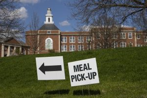Signs offering directions for meal pickup are seen at City High School on Sunday, April 26, 2020. 