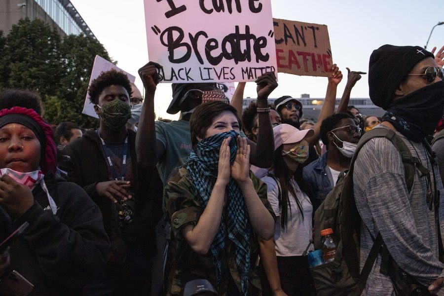 Chloe Bender (center) shouts at police stand in front of the police during a protest outside of the Des Moines police station on Friday, May 29, 2020. An organized peaceful rally in honor of George Floyd and other victims of police brutality turned to violence following the event. Protesters threw water bottles at police while police sprayed tear gas and flares were thrown. Bender was later tear gassed by police. 