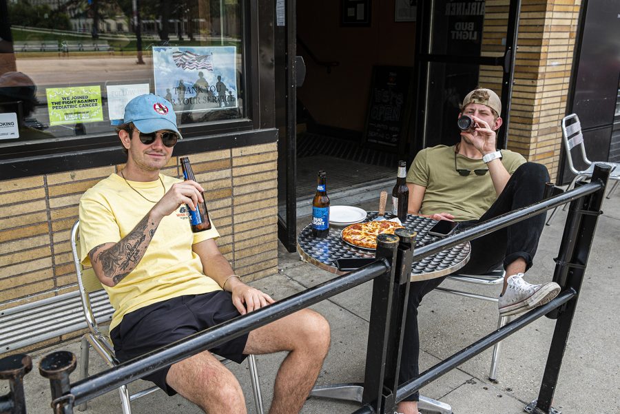 University of Iowa juniors Harrison Akienn and Michael Sehelbrop enjoy pizza and beer at the Airliner on Saturday, May 16th, 2020. The Airliner as well as various other local businesses are experiencing a surge in business due to commencement weekend and the state government lifting certain quarantine regulations. 