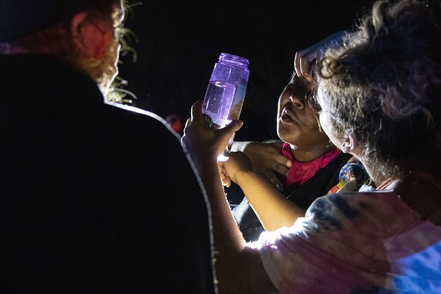 Crowd members help each other rinse their eyes with water after being pepper sprayed by police outside of Coral Ridge Mall in Coralville on Monday, June 1, 2020. Social media posts circulated Twitter and Facebook encouraging looters to break into the mall at 10:30 p.m. Police blocked the entrances and the crowd became violent as a man rushed an officer and police used pepper spray and flash bangs on the crowd. Several nearby businesses had property damage to windows and some protesters were handcuffed. 