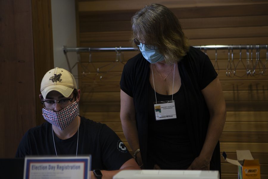 Precinct Election Chairperson Suzanne Micheau helps Precinct Election Official Lucas DeWitt register a votor on Tuesday, June 2 at Terry Trueblood Recreation Area.