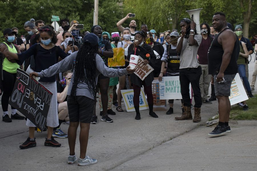 A protester addresses Iowa City Mayor Bruce Teague on Friday, June 12 outside the mayors house in Iowa City. Protesters walked together and gathered in the neighborhood to demand more action done from the mayor and city council. 