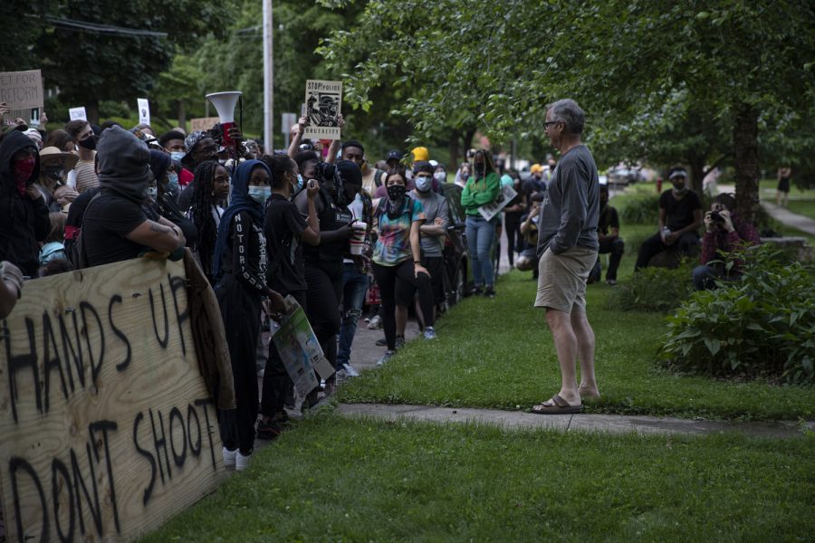 John Thomas, a member of the Iowa City City Council, stands outside his home and in front of a crowd of protesters on Saturday, June 13. The crowd was participating in a march to support the Black Lives Matter movement and congregated outside Thomas house to ask what he is doing as a member of the city council to address their demands. 