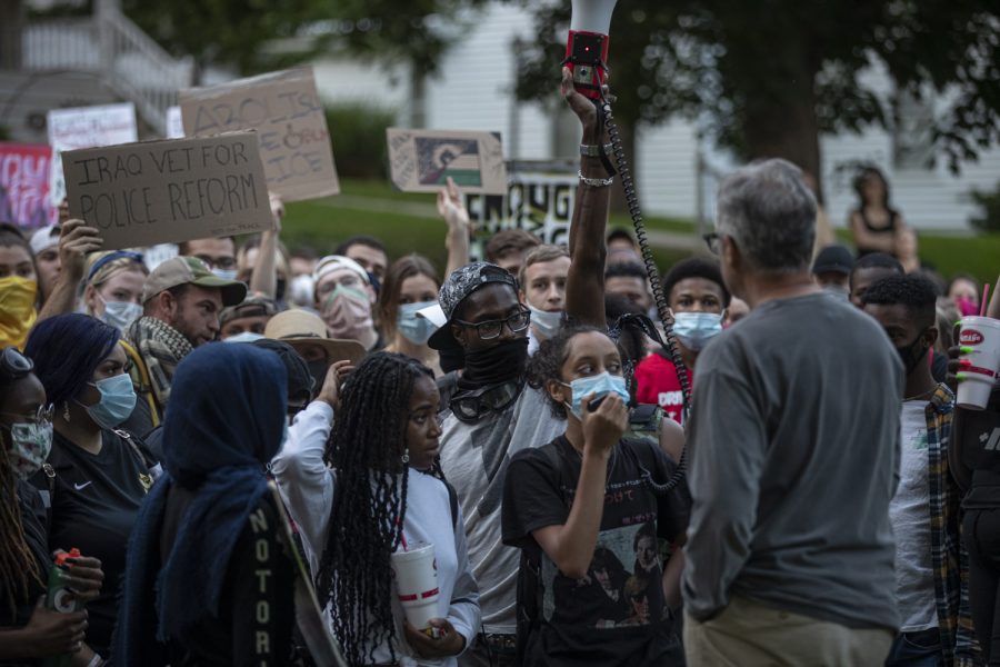 A crowd of protesters demands action from Iowa City City Council member John Thomas during a march to support the Black Lives Matter movement and protest police brutality on Saturday, June 13 in Iowa City. The crowd gathered in front of his house on Brown Street for twenty minutes and left after Councilman Thomas promised to be dedicated to meeting their demands. 