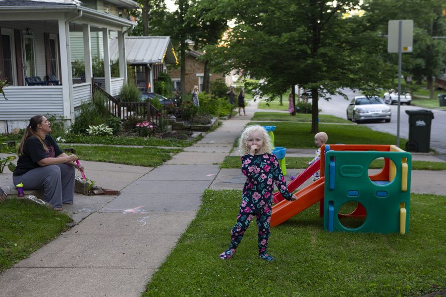 Kristine Djerf howls with her children, Sylvia and Oscar, on Tuesday, June 16, 2020 at their home in the Northside in Iowa City. Every night at 8 residents in the neighborhood stand outside and howl together for a few minutes to raise morale. 