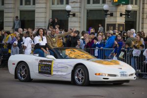 Grand Marshal BJ. Armstrong rides in a Corvette during the 2019 Homecoming Parade on Oct. 18 in Downtown Iowa City.