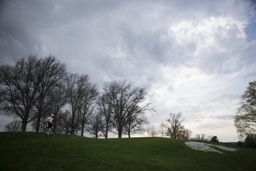 Iowas Matthew Walker eyes the stormy skies rolling in during the Hawkeye Invitational at Finkbine Golf Course on Saturday, April 15, 2017. Iowa currently sits in third after one and a half rounds in the tournament, play was delayed late Saturday afternoon due to inclement weather. 