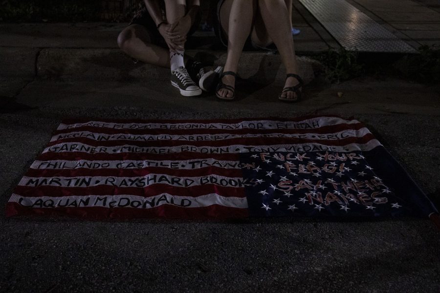 An American flag painted by an Iowa City resident with the names of Black people killed by the police is seen on Saturday, July 4, 2020 on Linn Street in Iowa City. After multiple speakers shared personal stories of inequality at the Pentacrest, protesters celebrated an unveiling of a mural by Robert Moore and Dana Harrison that showcases support for Black lives.