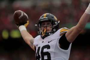 Iowa tight end George Kittle holds up the ball after scoring a touchdown during the Iowa-Nebraska game at Memorial Stadium on Friday, Nov. 27, 2015. Kittle scored the first touchdown of the game. The Hawkeyes defeated the Cornhuskers, 28-20, to finish off a perfect regular season.