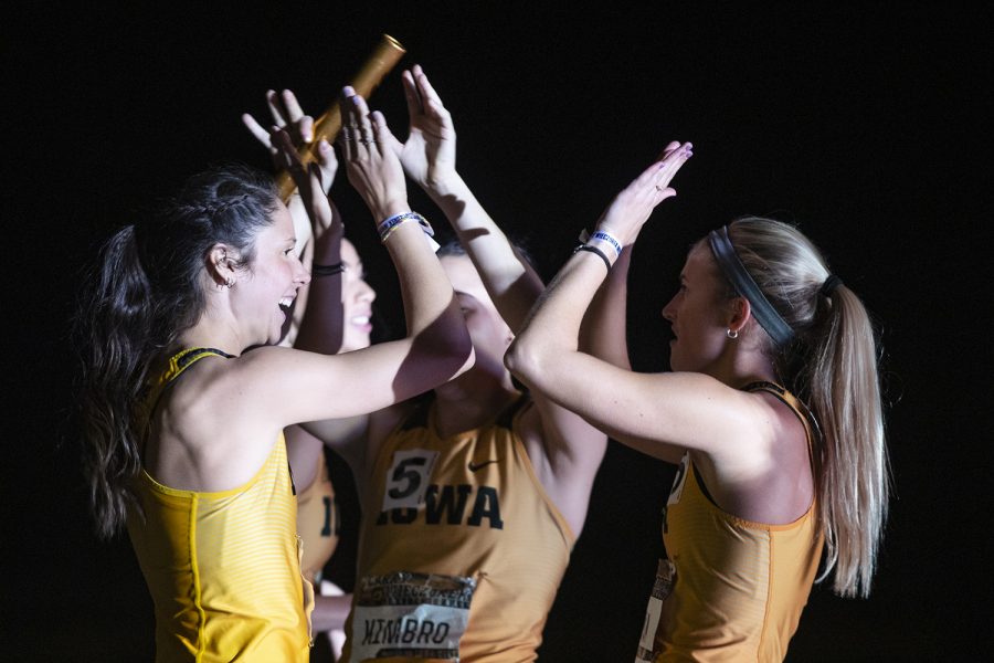 Iowa’s Mallory King high fives 4x400m relay premier teammates Davicia Patterson, Jenny Kimbro, and Aly Weum during the Larry Wieczorek Invitational at the University of Iowa Recreation Building on Jan. 18, 2020. The group took second in the premier with a 3:39.67.