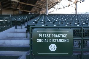 A sign reminding photographers to social distance is seen in the stands at Wrigley Field in Chicago, Ill. (Chris Sweda/Chicago Tribune/TNS)