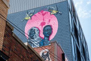 A mural painted by Robert Moore and Dana Harrison is seen atop Oasis in Iowa City on Thursday, July 2, 2020. The mural was finished within 24 hours on June 25, as a celebration of black lives and equality in Iowa City.