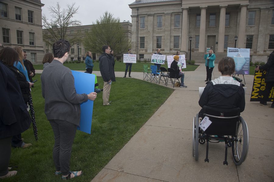 Rally attendees hold signs and listen to speakers on the Pentacrest on Wednesday, May 1, 2019. UI Students for Disability Advocacy & Awareness organized this rally to speak about the injustice that students with disabilities face on campus.