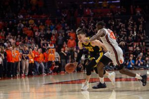 Iowa guard Connor McCaffery drives past Illinois DaMonte Williams during a game on Sunday, March 8, 2020 at the State Farm Center in Champaign, Ill. The Hawkeyes lost to the Fighting Illini, 76-78. 