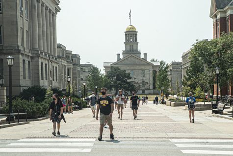 University of Iowa students walk across the T.Anne Cleary walkway on their first day of the new semester on Monday, August 24th, 2020. Despite the pandemic, campus remains open and some classes are still being held in person.