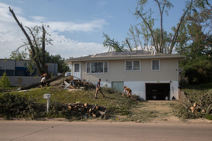 The Welsh family works to clean up their yard three days after sustaining significant damage from the derecho that swept through Iowa on Monday, August 10. The majority of the damage was caused by large branches falling from the tree next to their house, which is located on 33rd Street in Cedar Rapids.