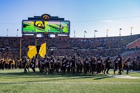 Iowa players run onto the field during a football game between Iowa and Minnesota at Kinnick Stadium on Saturday, Nov. 16, 2019. The Hawkeyes defeated the Gophers, 23-19.