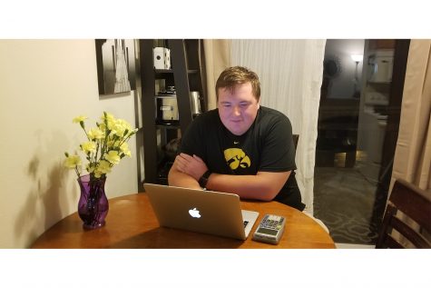 Graduate student Carter Cook studies for his online classes in his apartment. He only has one in-person discussion this semester. 