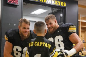 Offensive Linemen Levi and Landon Paulsen talk to Kid Captain Enzo Thongsoum in the Hawkeye football locker room at Kids Day at Kinnick on Saturday, August 10, 2019. Kids Day at Kinnick is an annual event for families to experience Iowas football stadium, while watching preseason practice and honoring this years Kid Captains.