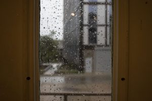 Rain is seen through a window on Monday, Aug. 10, 2020. With wind gusts around 80 mph, the derecho ­--a widespread wind damage event produced by severe thunderstorms-- hit Iowa City in the afternoon causing tree damage and power outages. 