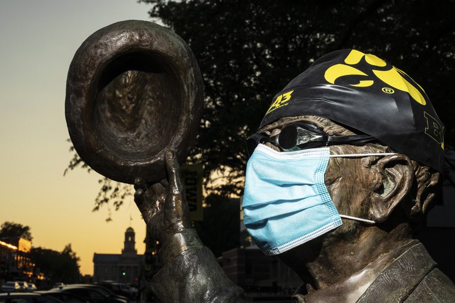 A statue clad with swim cap, goggles, and face mask depicting former historian and University of Iowa athlete Irving Weber stands near the Van Allen building on Sunday, August 23, 2020, two days after the decision by the University of Iowa to cut the mens and womens swim and dive program along with mens gymnastics and mens tennis. While known for his work as a historian in Iowa City, Weber also maintains importance as the first All-American swimmer at Iowa, gaining the status in 1922 in the 150 yard backstroke. (Ryan Adams/The Daily Iowan)