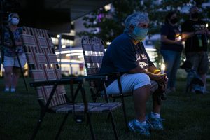 TIffin resident, Karen Kieth-Zamora sit in silence during a candlelight vigil at University of Iowa Hospitals and Clinics on Monday, August 26th, 2020. SEIU, along with several nurses and community members held a candlelight vigil to honor the nurses who passed away from COVID-19. 